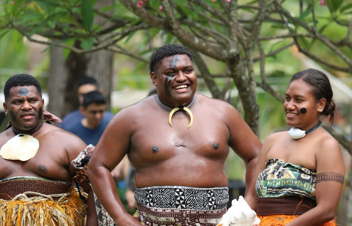 Hawaiian dancers in traditional dress performing on stage