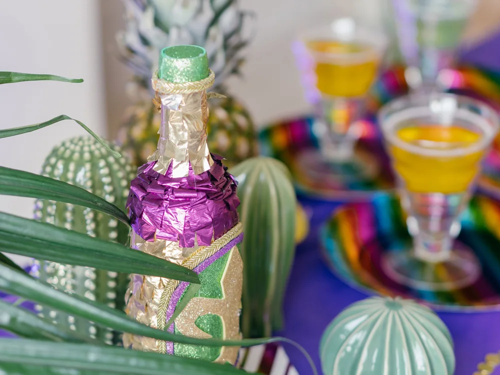 A tropical-themed table set with cocktails and a pineapple centrepiece